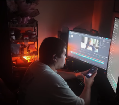 Richard Dy editing video content at his workstation